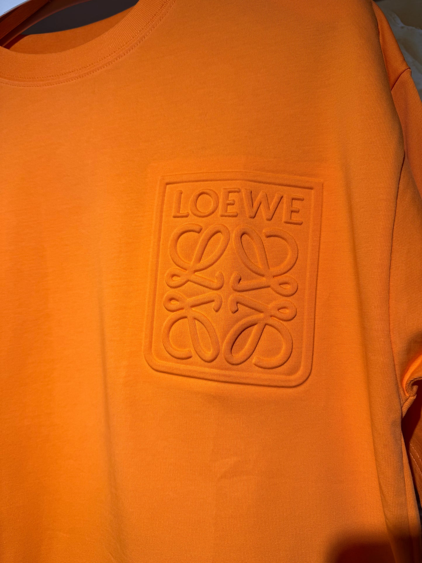 Loewe “Anagram Pocket Embossed T-Shirt”.