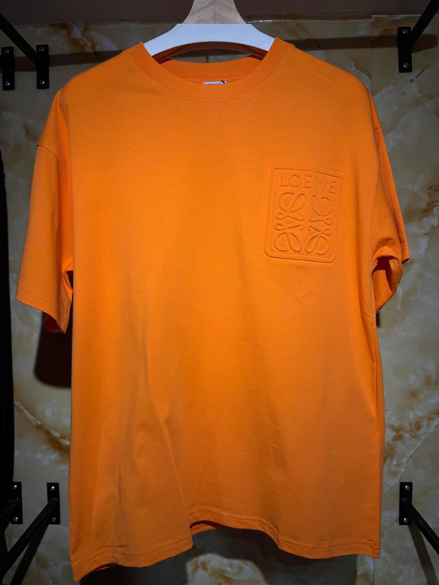 Loewe “Anagram Pocket Embossed T-Shirt”.